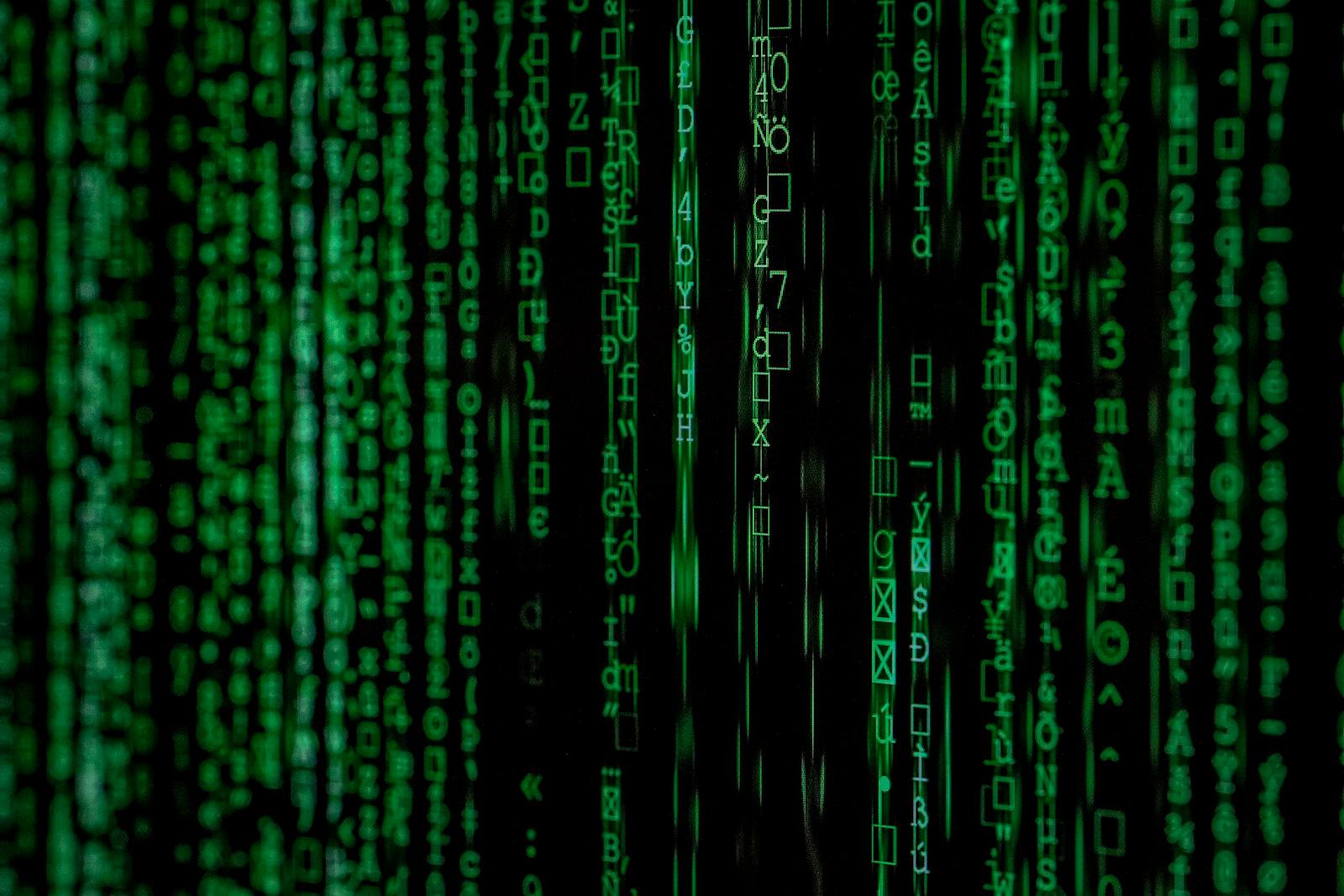 Streams of encrypted green code on a dark screen